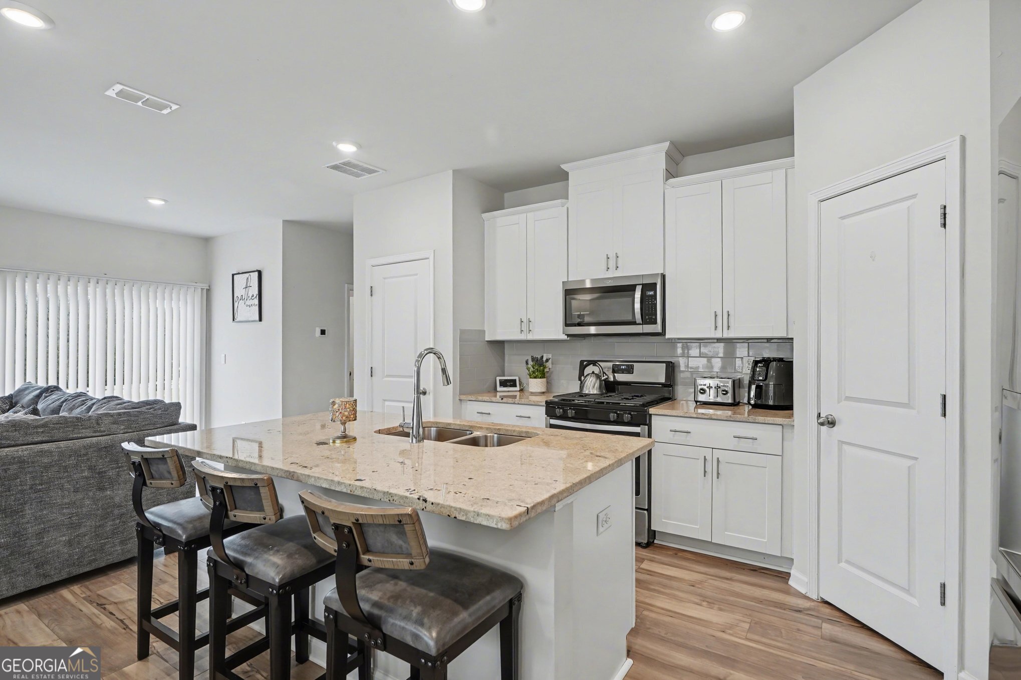 316 Warner Road McDonough, GA 30253 - Photo 7 of 27 a kitchen with a sink chairs and refrigerator