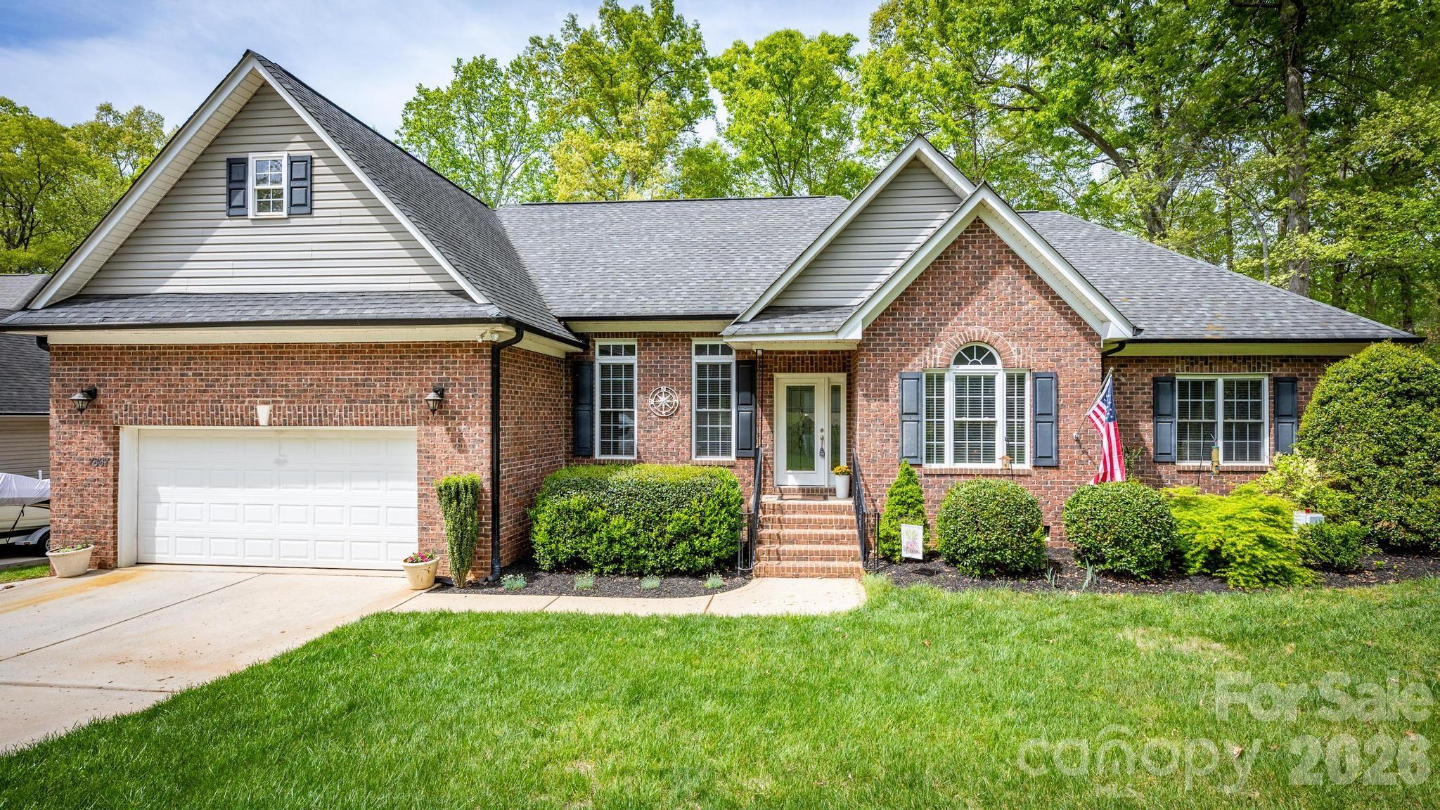 7867 Golf Course Drive North Denver, NC 28037 - Photo 1 of 34 a front view of a house with a yard and garage
