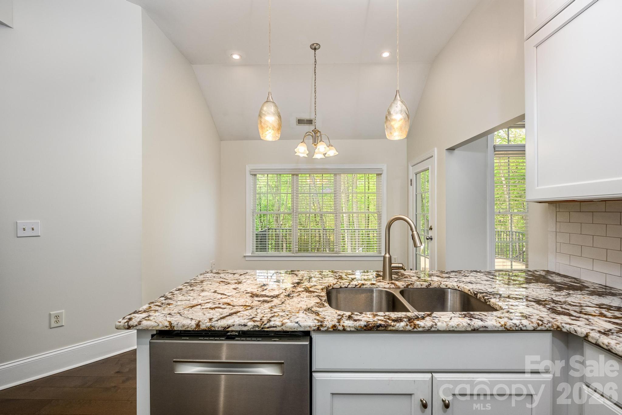 7867 Golf Course Drive North Denver, NC 28037 - Photo 11 of 34 a kitchen with granite countertop a sink and a window