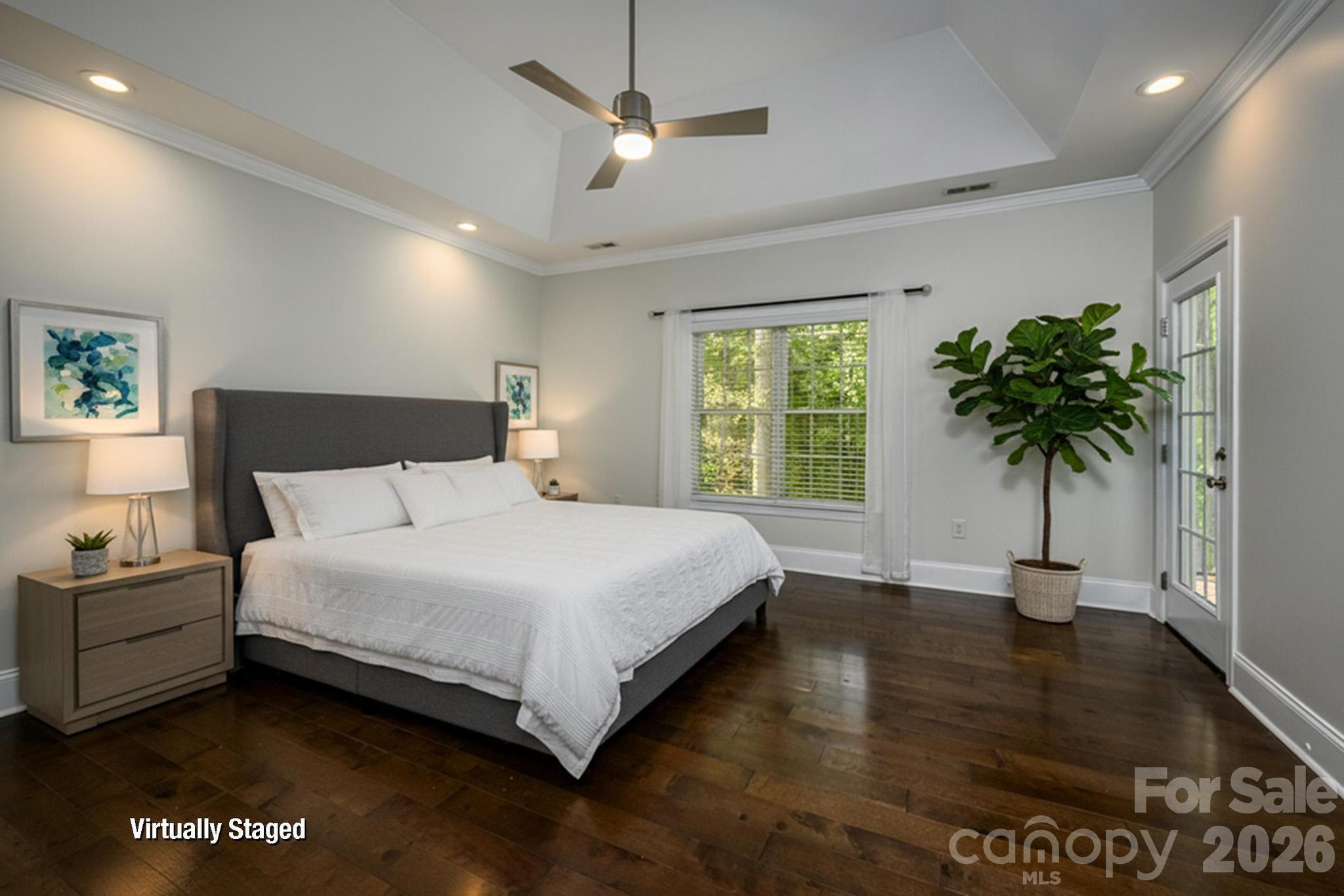 7867 Golf Course Drive North Denver, NC 28037 - Photo 14 of 34 a bedroom with a bed window and a chandelier