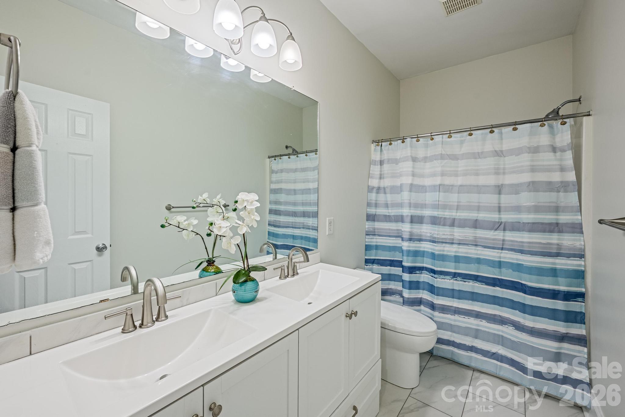 7867 Golf Course Drive North Denver, NC 28037 - Photo 20 of 34 a bathroom with a sink a toilet and shower