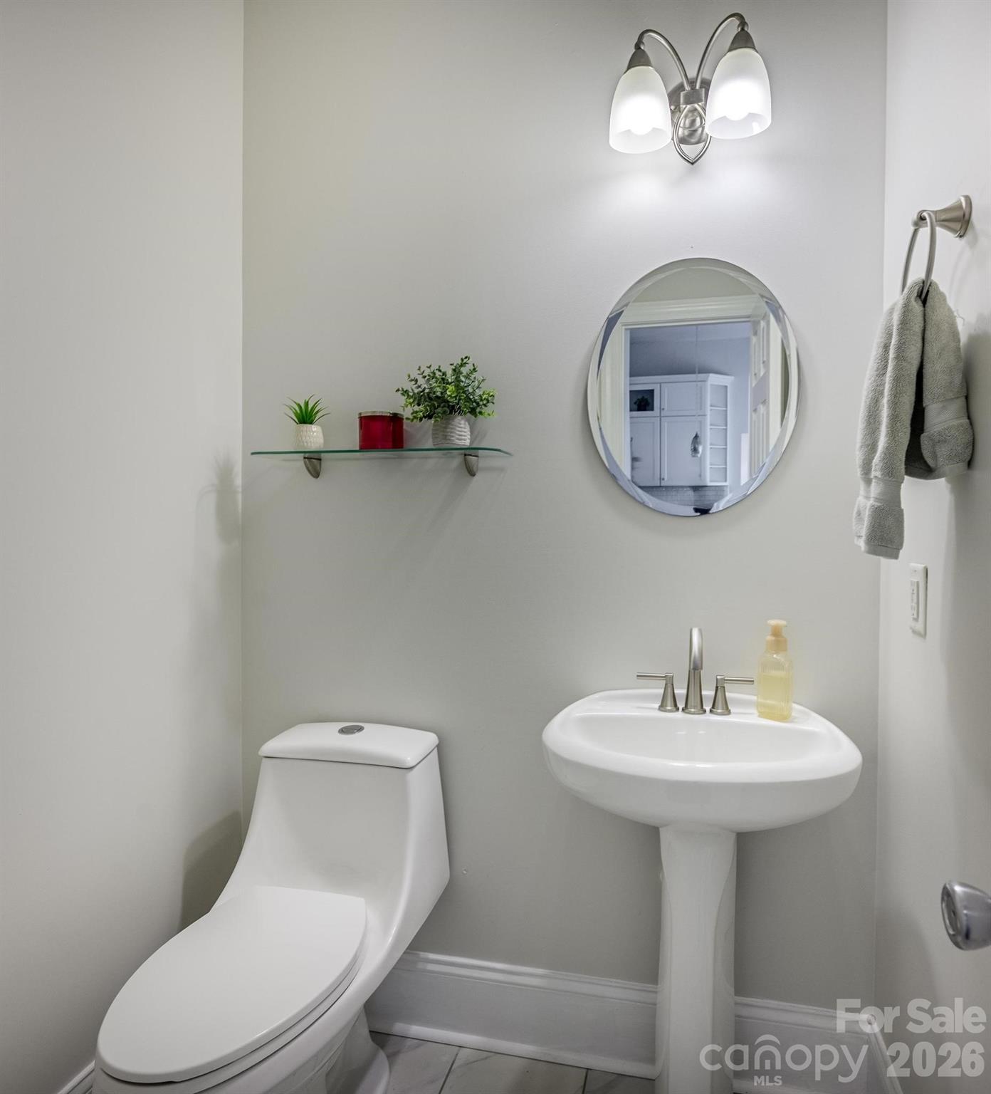 7867 Golf Course Drive North Denver, NC 28037 - Photo 23 of 34 a bathroom with a toilet sink and mirror