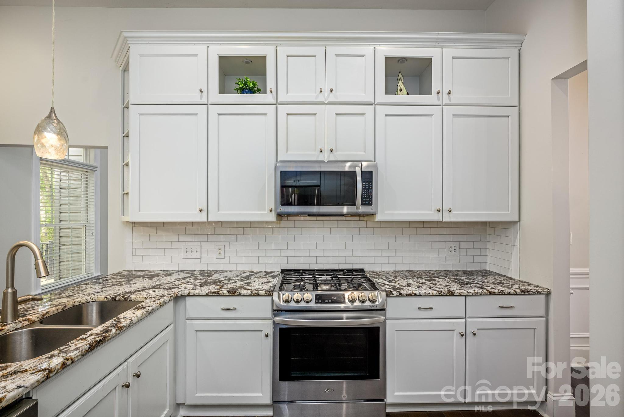 7867 Golf Course Drive North Denver, NC 28037 - Photo 9 of 34 a kitchen with white cabinets and white appliances