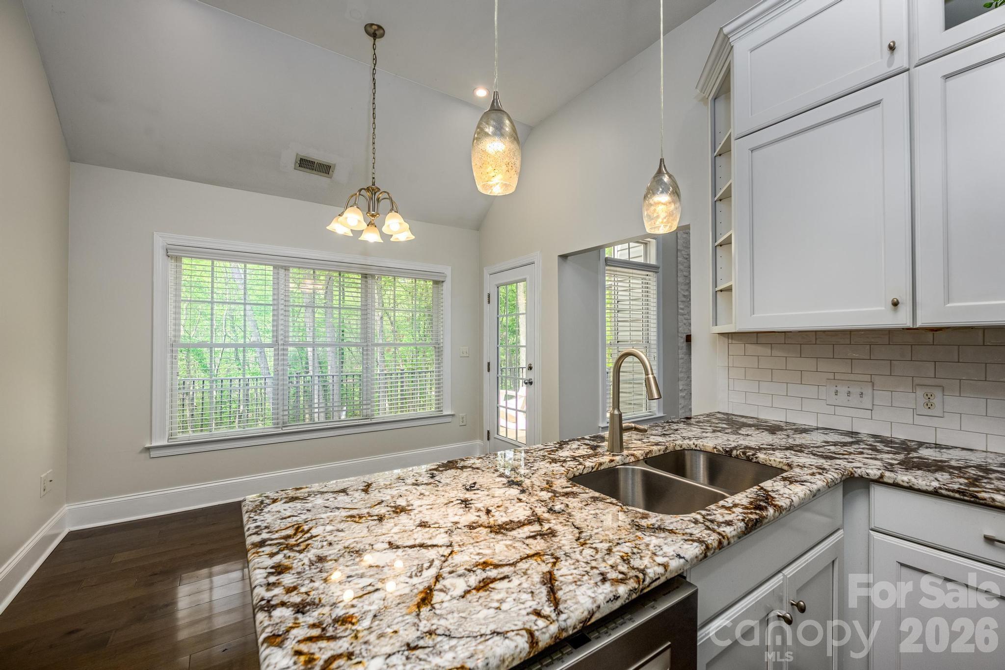 7867 Golf Course Drive North Denver, NC 28037 - Photo 10 of 34 a kitchen with a stove a sink dishwasher and a wooden floor