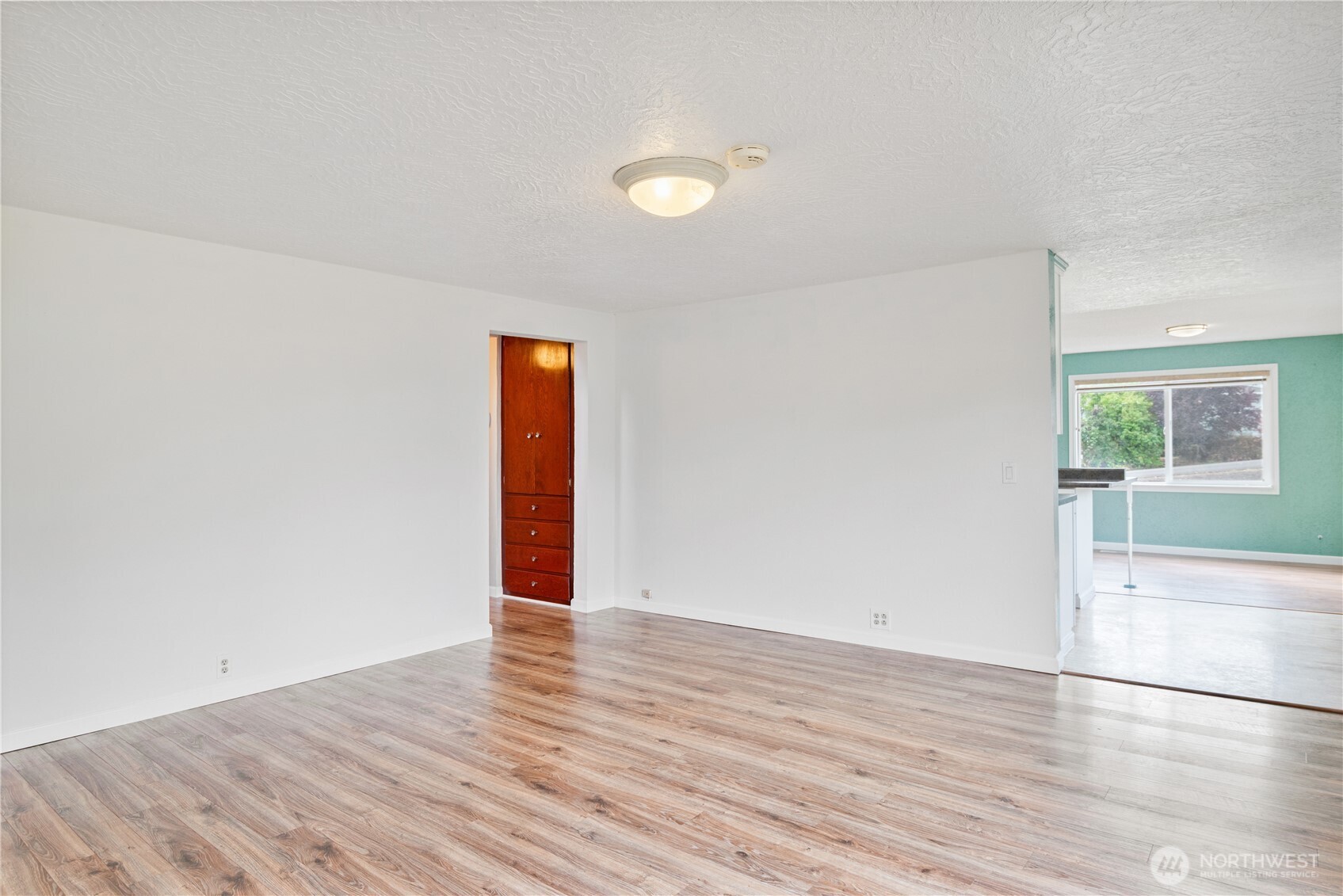 4630 Pleasant Hill Road Kelso, WA 98626 - Photo 6 of 39 a view of an empty room with wooden floor and a window