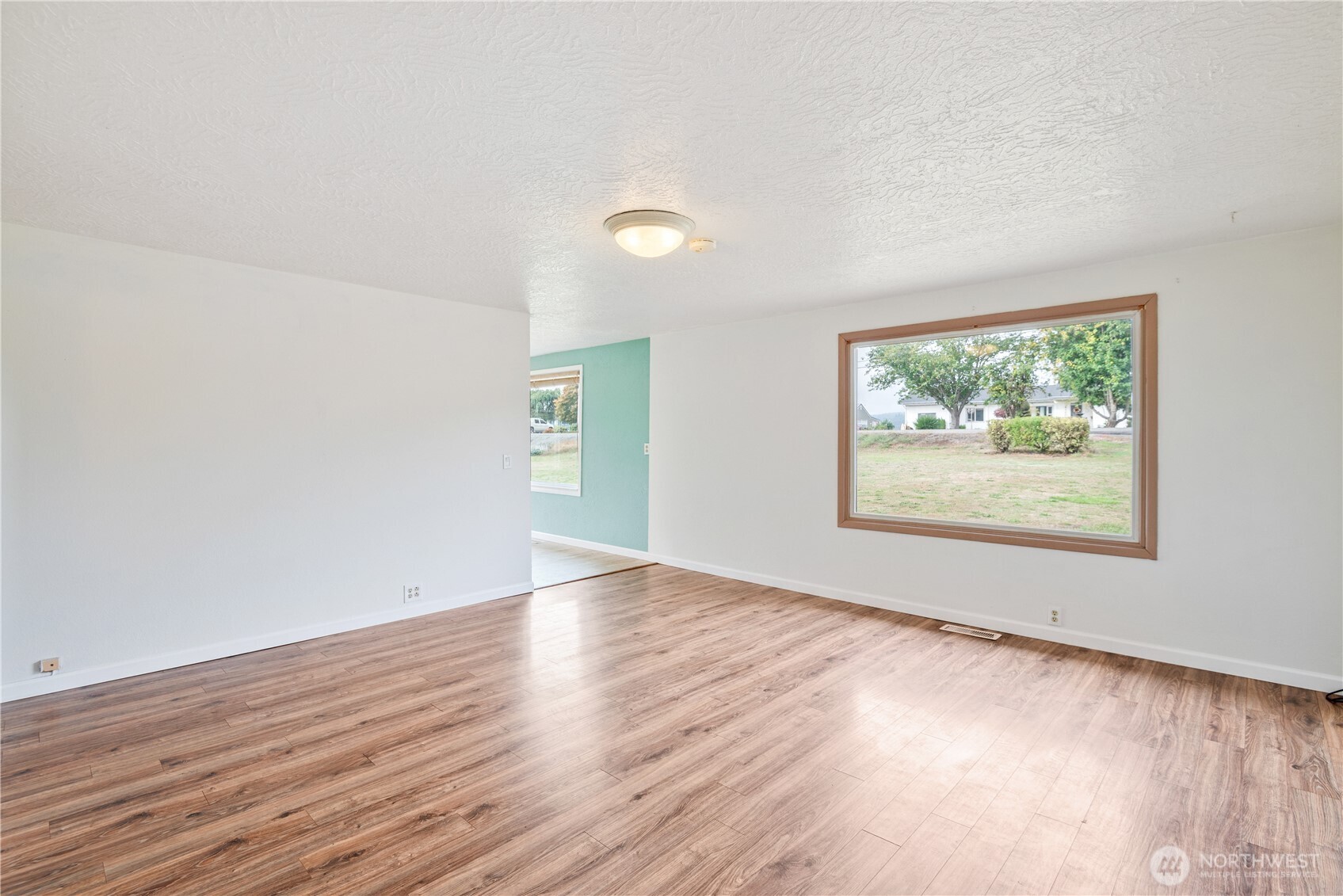 4630 Pleasant Hill Road Kelso, WA 98626 - Photo 7 of 39 a view of an empty room with wooden floor and a window