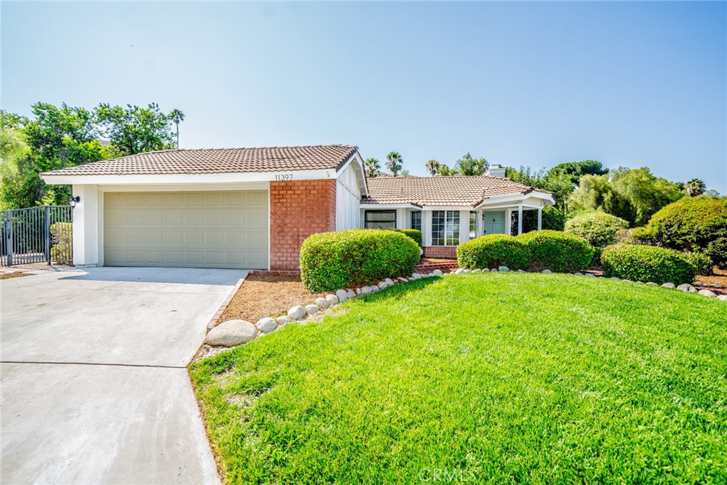 11397 Turningbend Way Riverside, CA 92505 - Photo 1 of 1 a front view of a house with a yard and garage