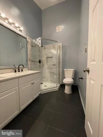 a bathroom with a double vanity sink toilet and shower