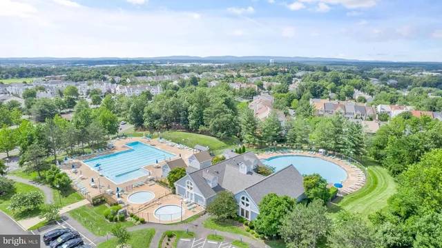 an aerial view of a house with a swimming pool patio and outdoor seating