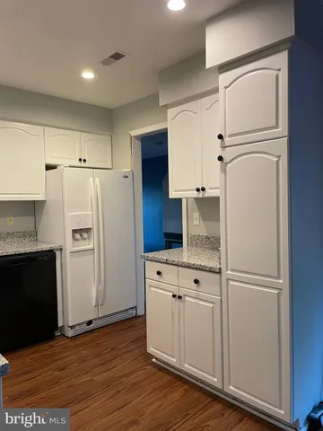 a white refrigerator freezer sitting in a kitchen