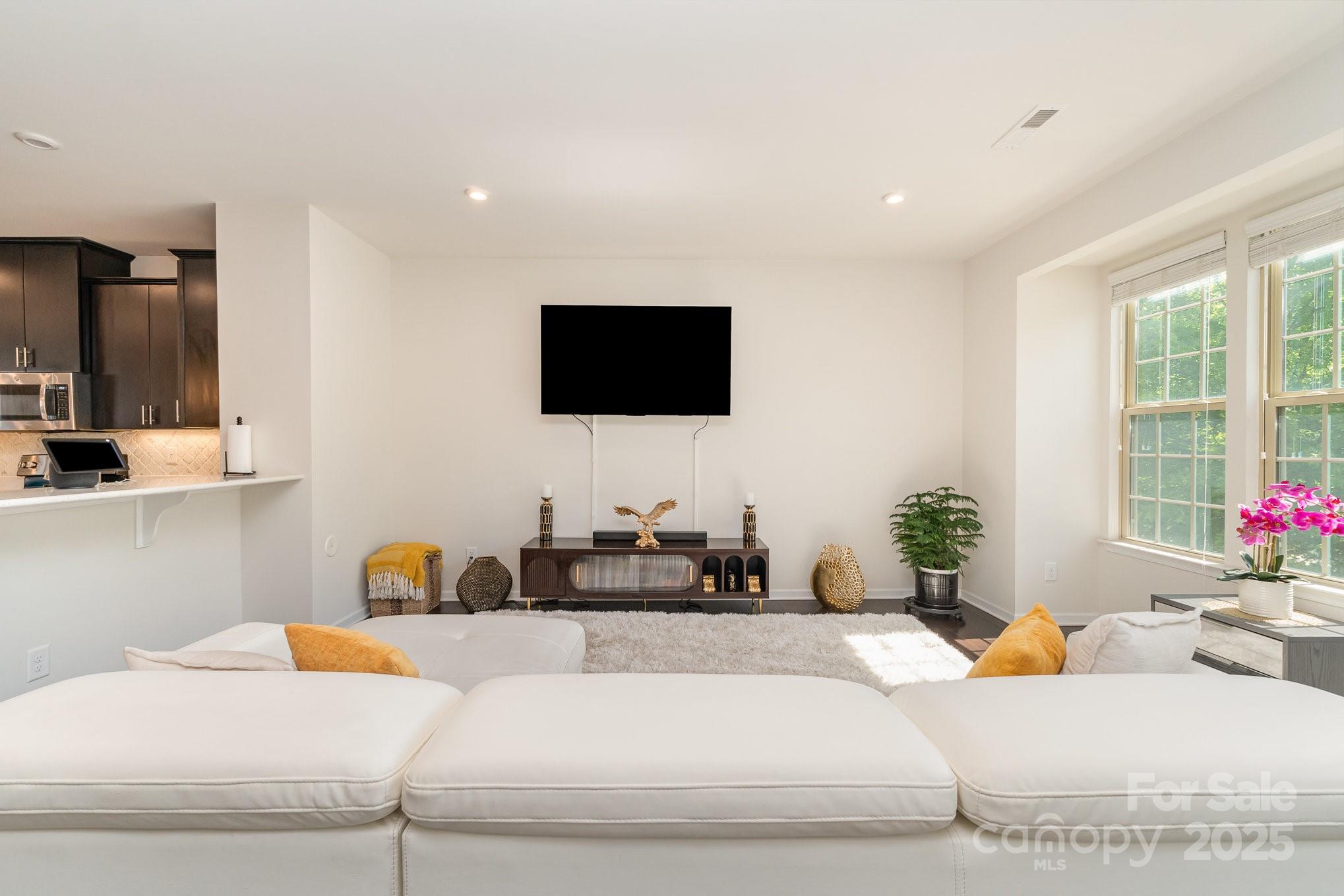 3718 Speer Boulevard Charlotte, NC 28217 - Photo 13 of 48 a living room with furniture and a flat screen tv