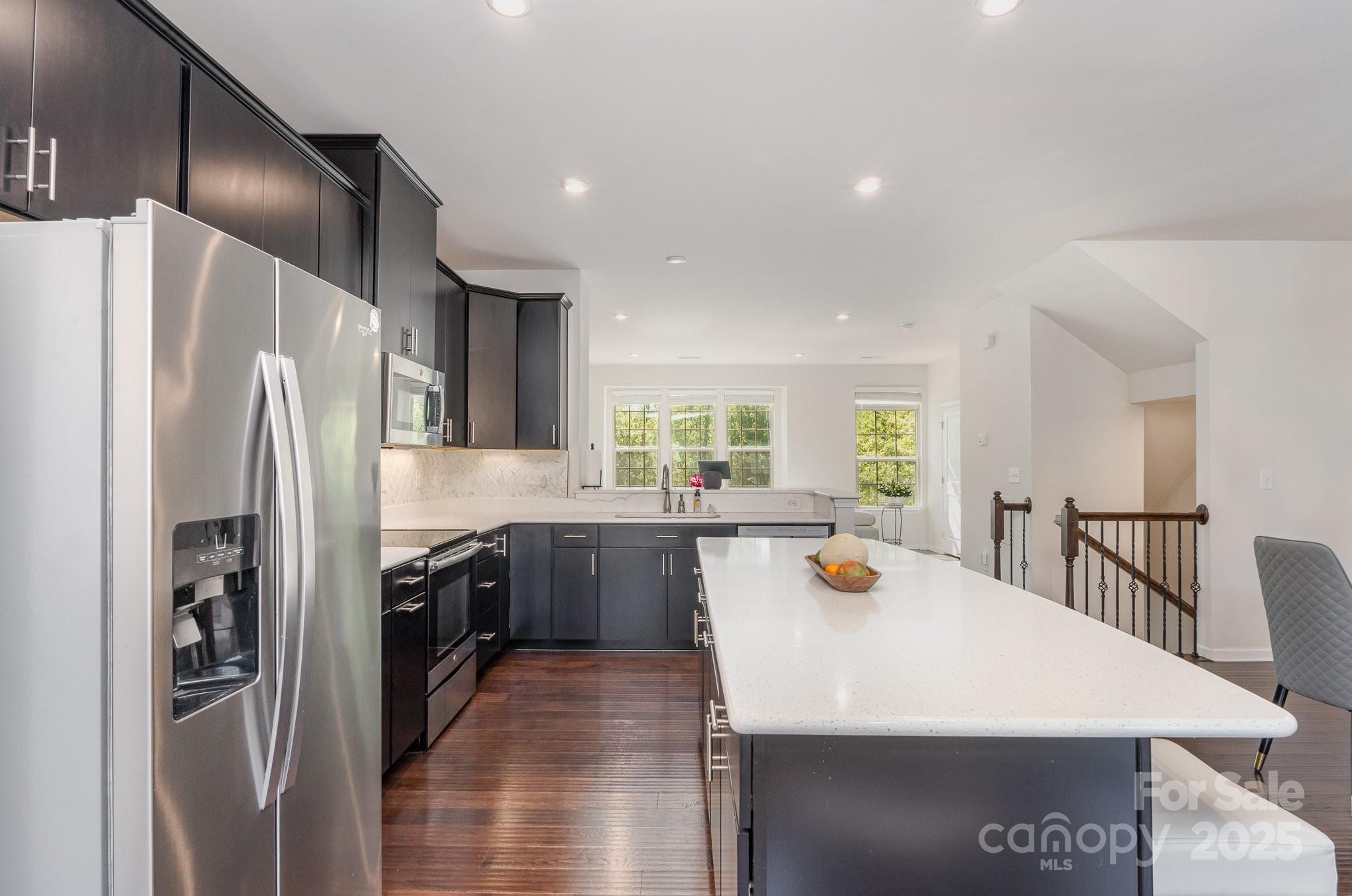 3718 Speer Boulevard Charlotte, NC 28217 - Photo 22 of 48 a kitchen with stainless steel appliances a refrigerator a sink a stove and island