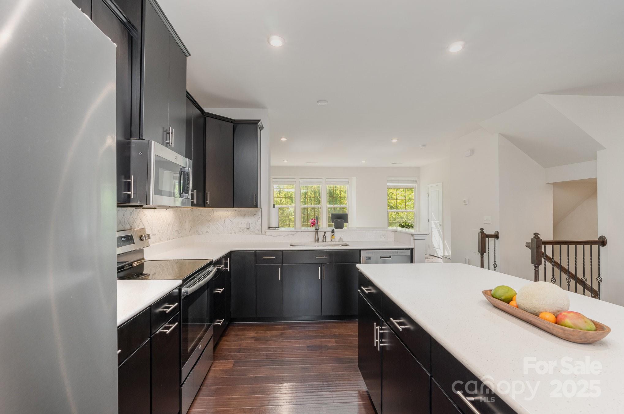 3718 Speer Boulevard Charlotte, NC 28217 - Photo 23 of 48 a kitchen with lots of counter space and wooden floor