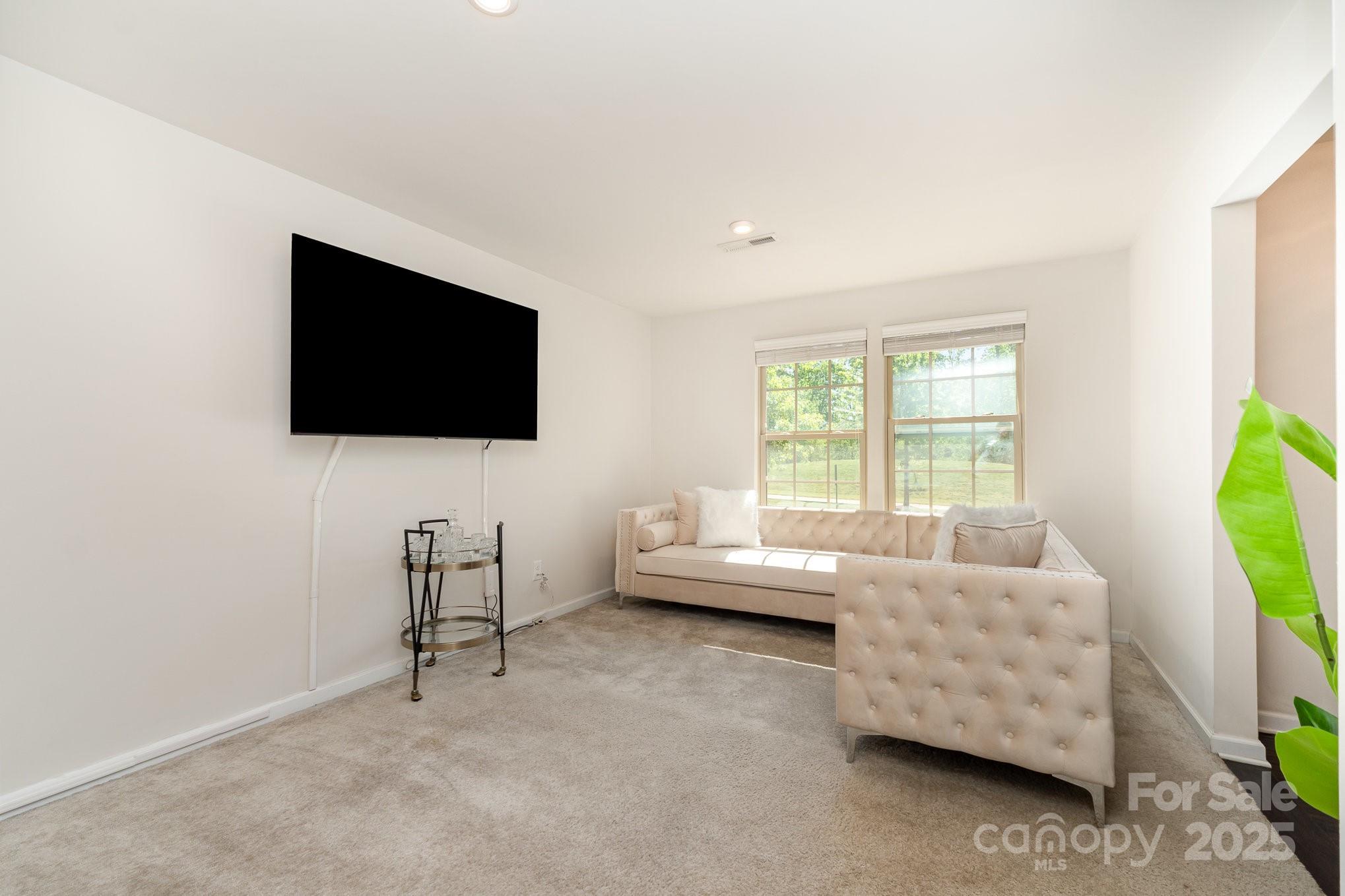 3718 Speer Boulevard Charlotte, NC 28217 - Photo 29 of 48 a living room with furniture and a flat screen tv