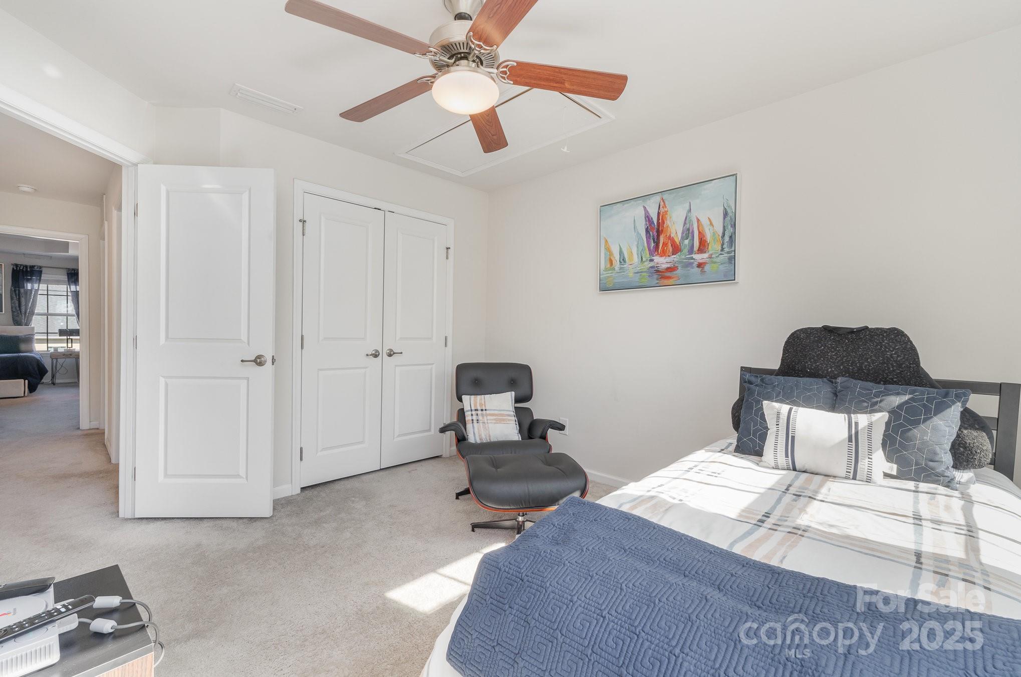 3718 Speer Boulevard Charlotte, NC 28217 - Photo 35 of 48 a bedroom with a bed and a chandelier