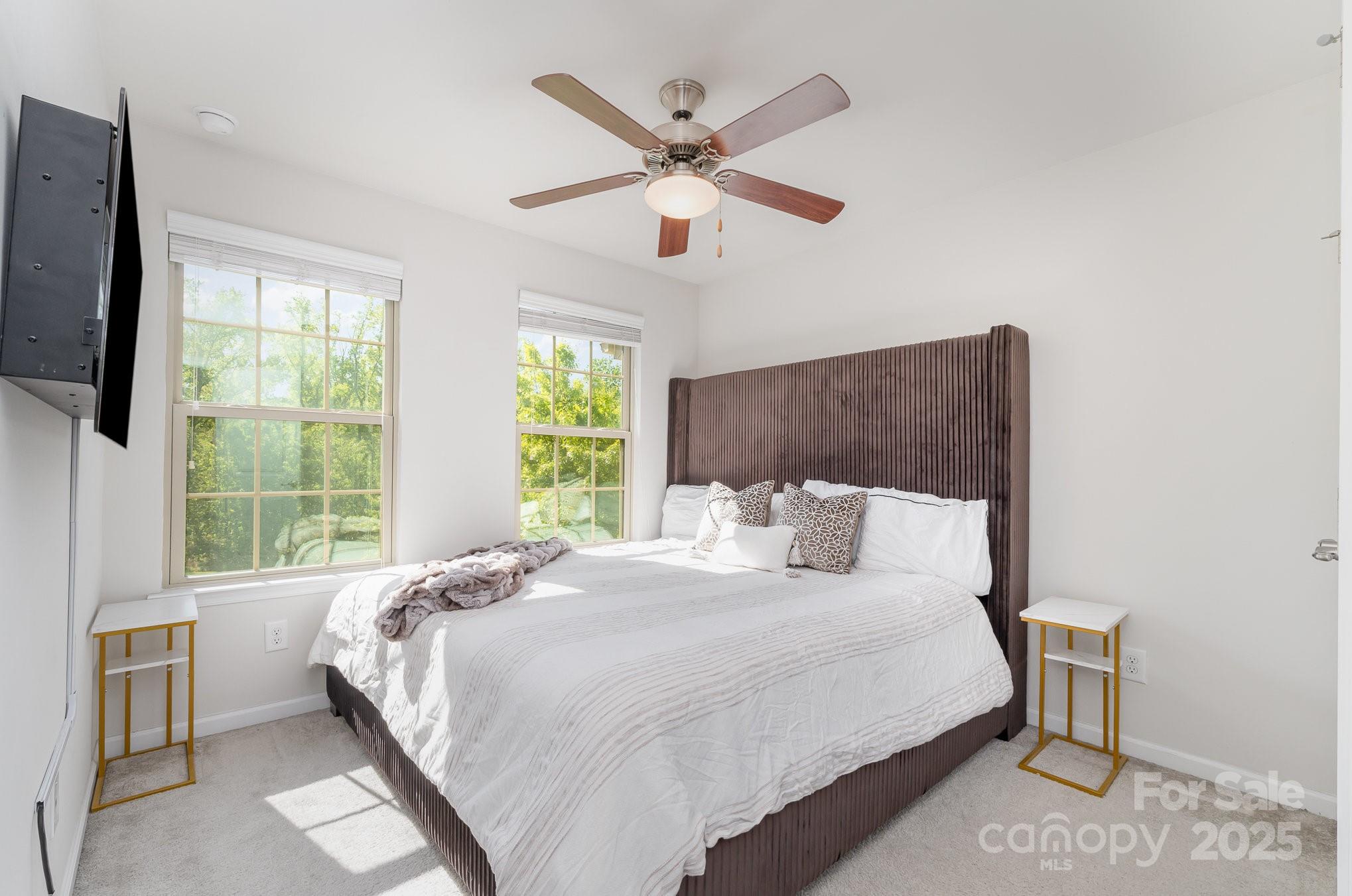 3718 Speer Boulevard Charlotte, NC 28217 - Photo 36 of 48 a bedroom with a large bed and a large window