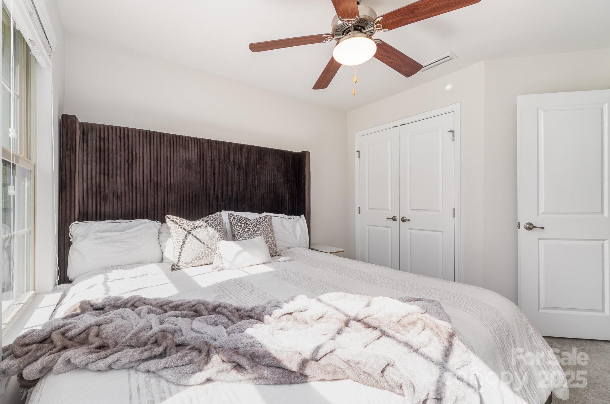 3718 Speer Boulevard Charlotte, NC 28217 - Photo 37 of 48 a bedroom with a large bed and a chandelier