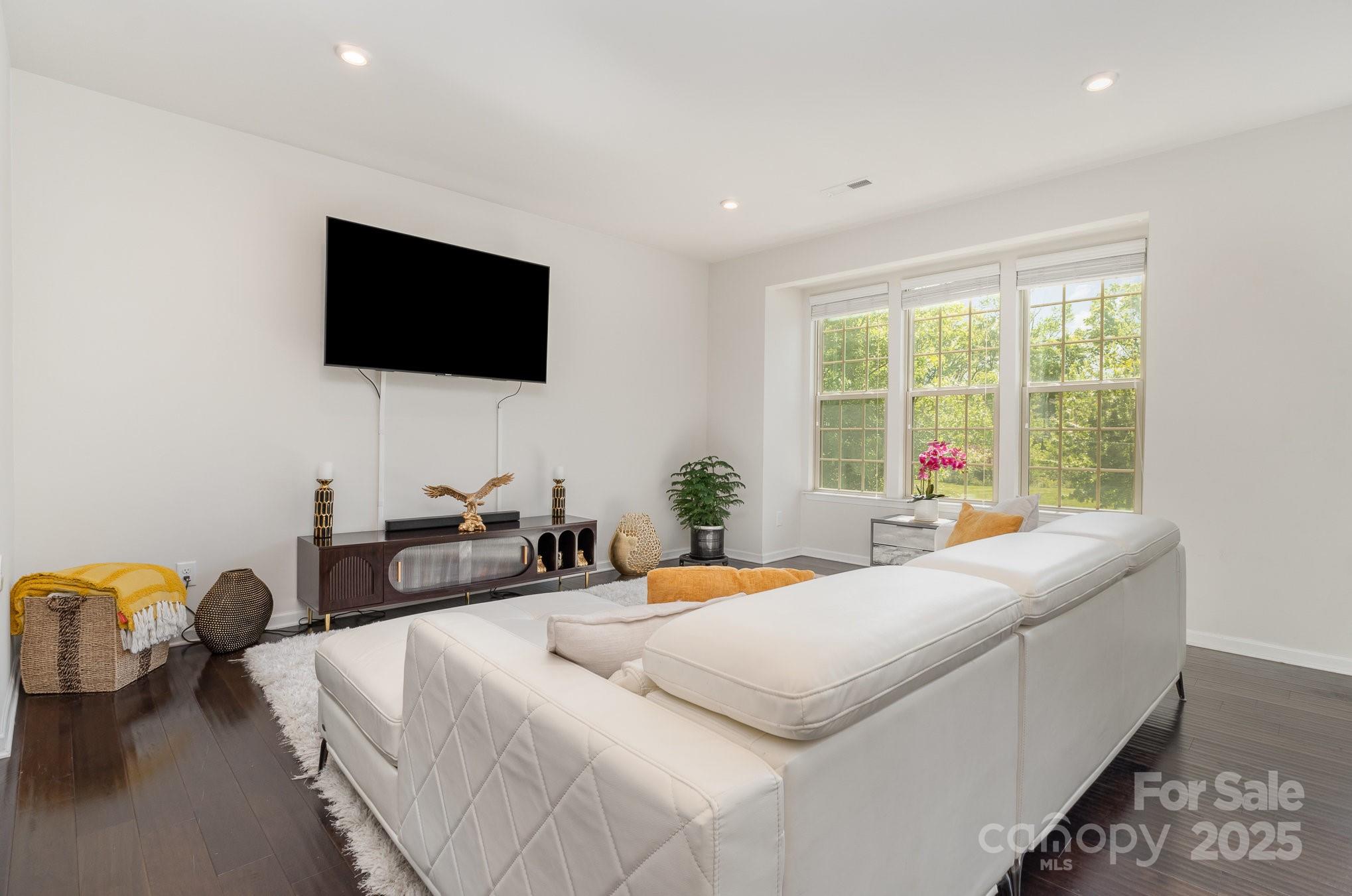 3718 Speer Boulevard Charlotte, NC 28217 - Photo 8 of 48 a bedroom with a bed and a flat screen tv