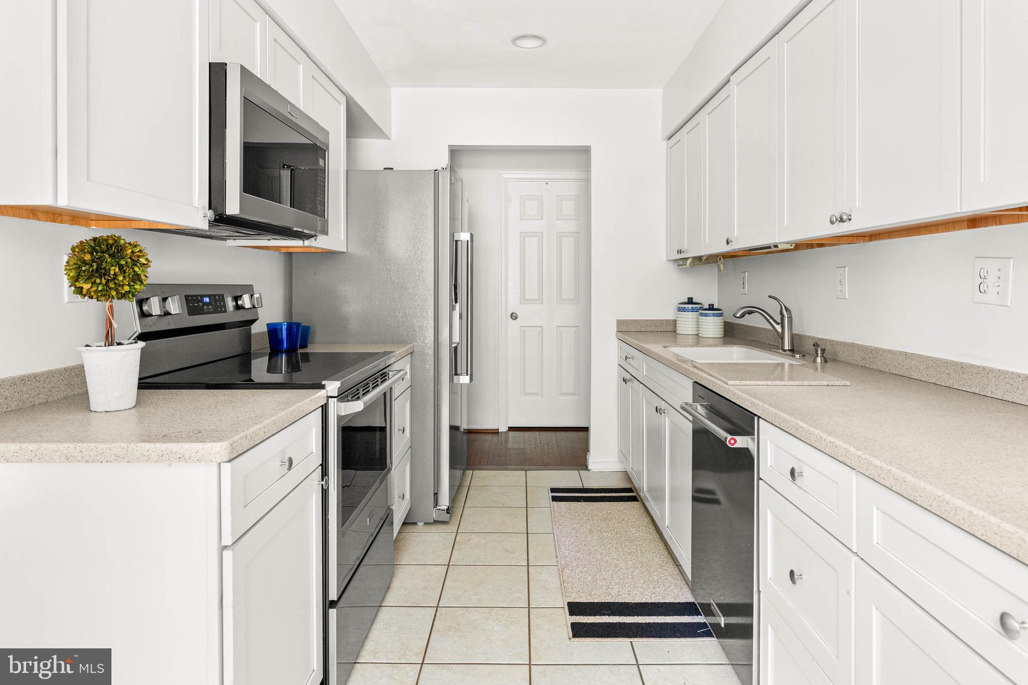 106 Bernard Court Chesterbrook, PA 19087 - Photo 12 of 30 a kitchen with a sink dishwasher stove and white cabinets