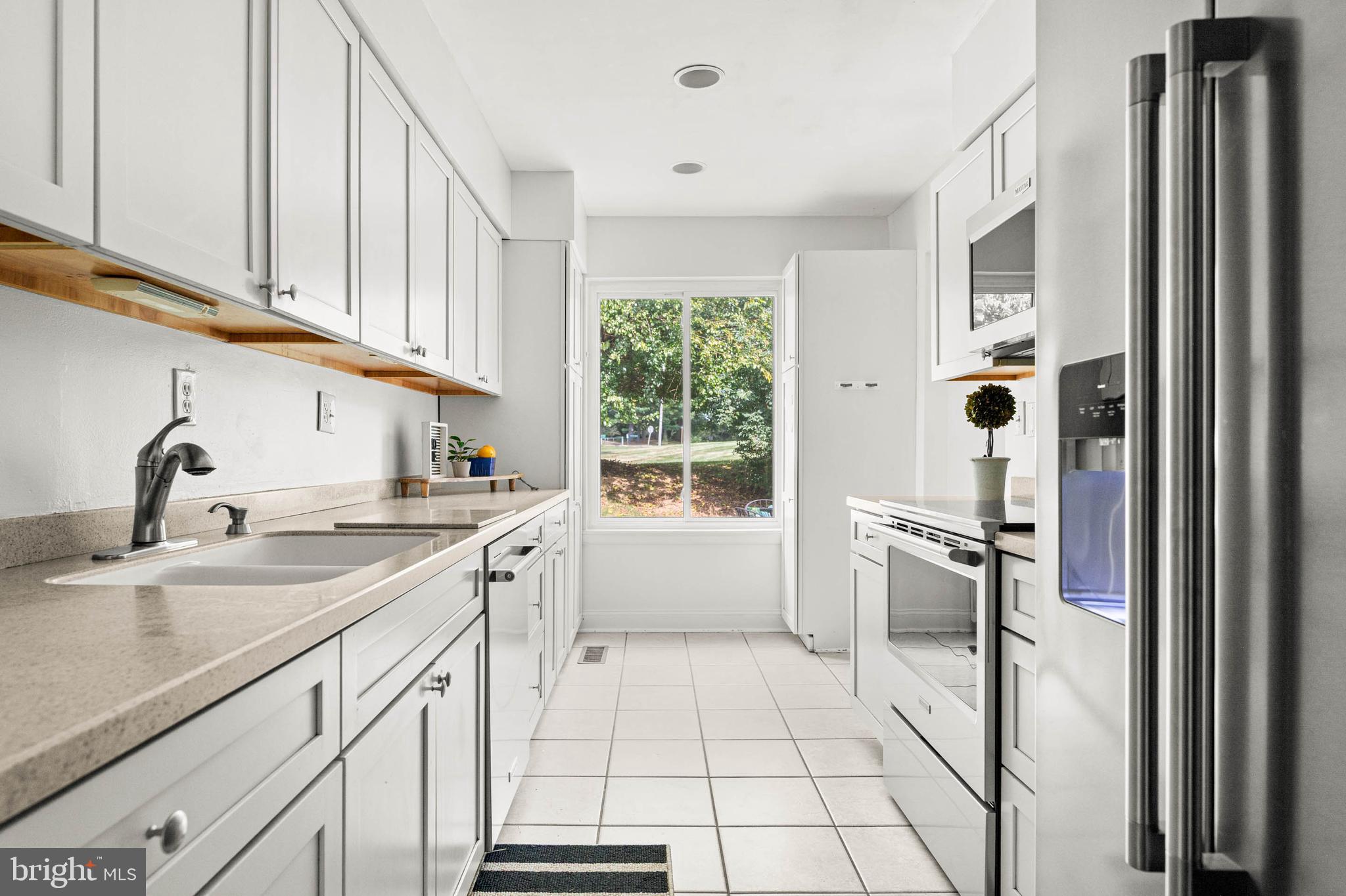106 Bernard Court Chesterbrook, PA 19087 - Photo 13 of 30 a kitchen with a sink refrigerator and cabinets