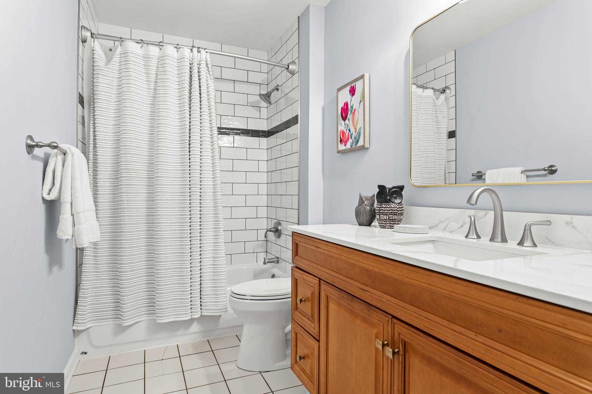 106 Bernard Court Chesterbrook, PA 19087 - Photo 22 of 30 a bathroom with a sink a toilet and shower curtain