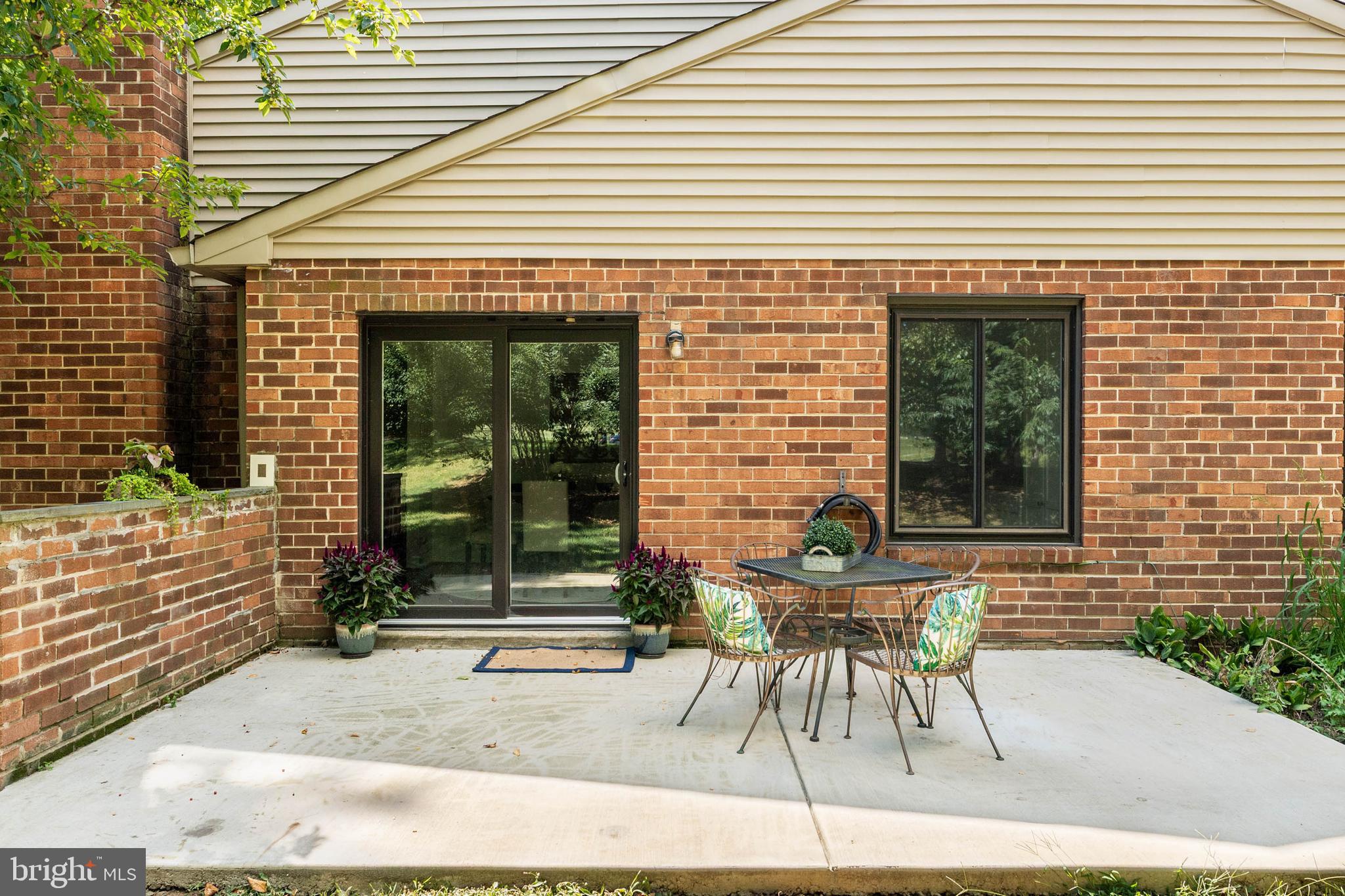 106 Bernard Court Chesterbrook, PA 19087 - Photo 28 of 30 a patio with a table and chairs and potted plants