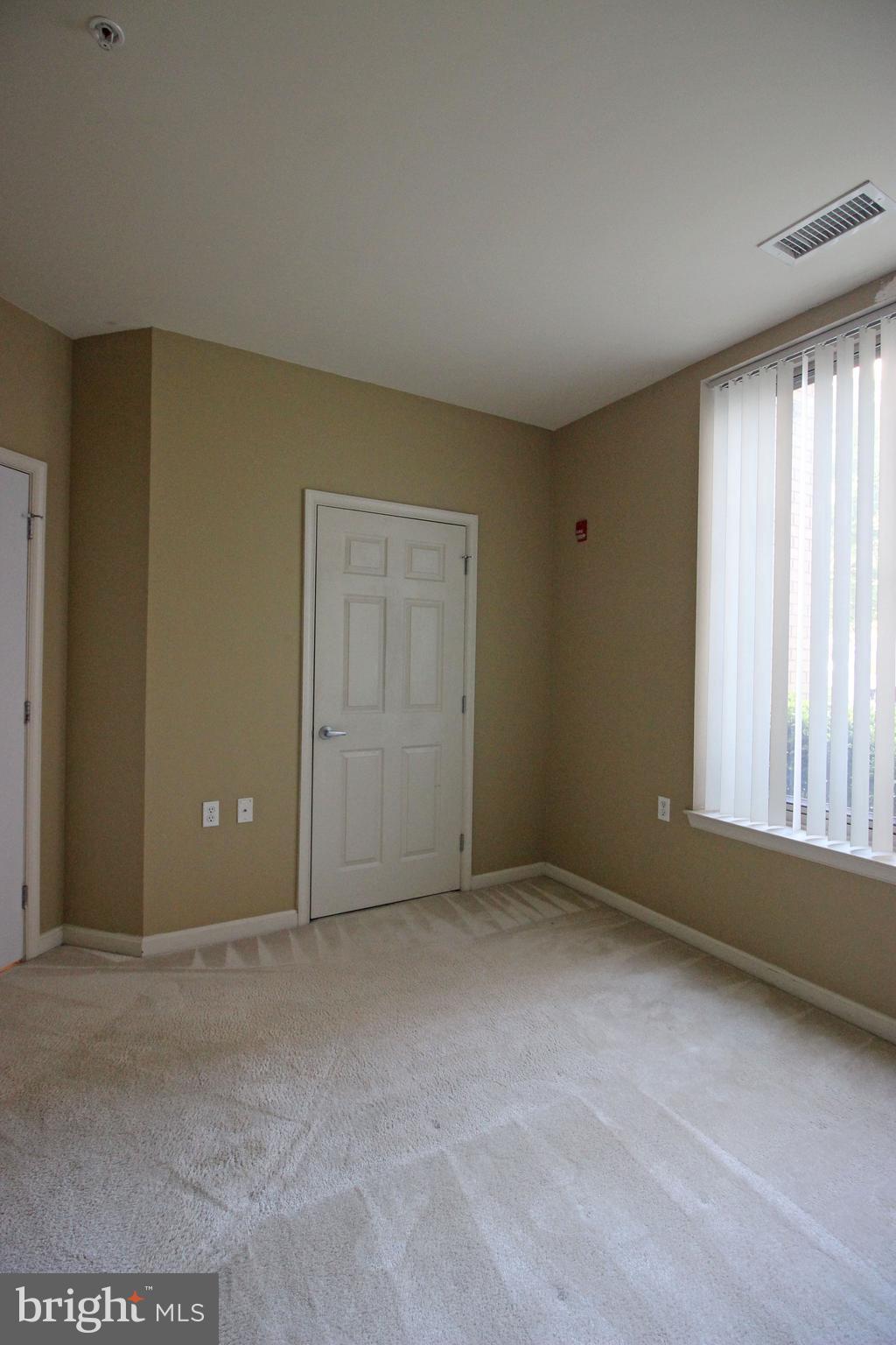 2726 Gallows Road, Unit 112 Vienna, VA 22180 - Photo 12 of 27 a view of an empty room with a window