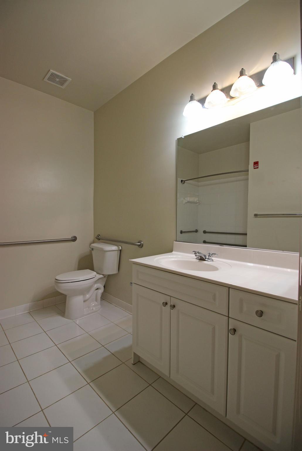 2726 Gallows Road, Unit 112 Vienna, VA 22180 - Photo 15 of 27 a bathroom with a toilet sink and mirror