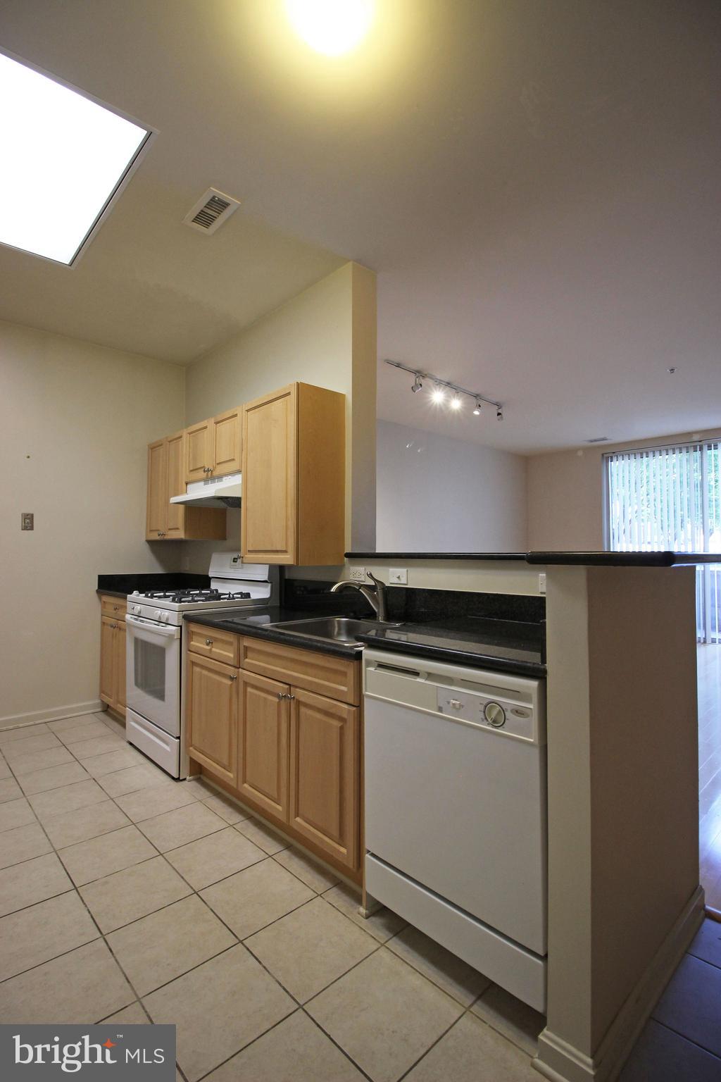 2726 Gallows Road, Unit 112 Vienna, VA 22180 - Photo 2 of 27 a kitchen with stainless steel appliances granite countertop a sink and a stove