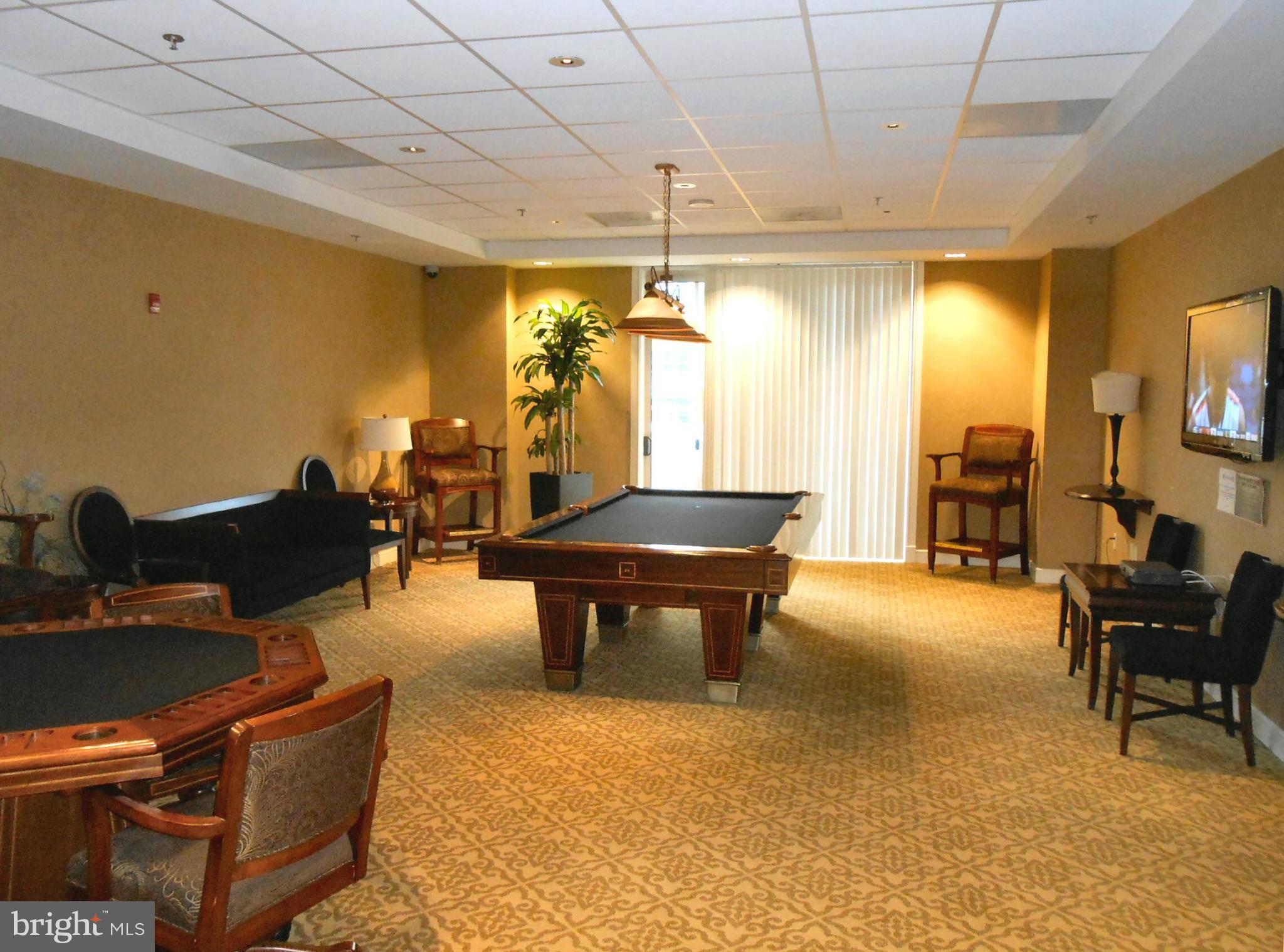 2726 Gallows Road, Unit 112 Vienna, VA 22180 - Photo 24 of 27 a living room with furniture a table and large windows