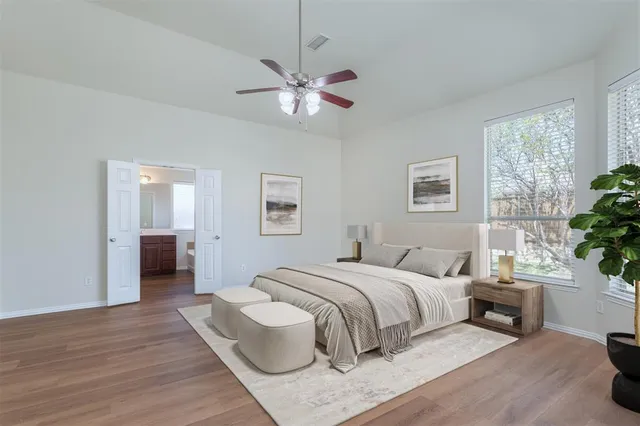 a bedroom with a large bed and a chandelier