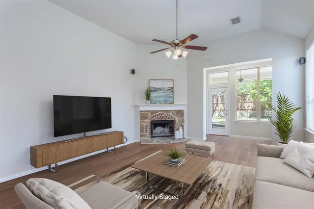 a living room with furniture and a fireplace