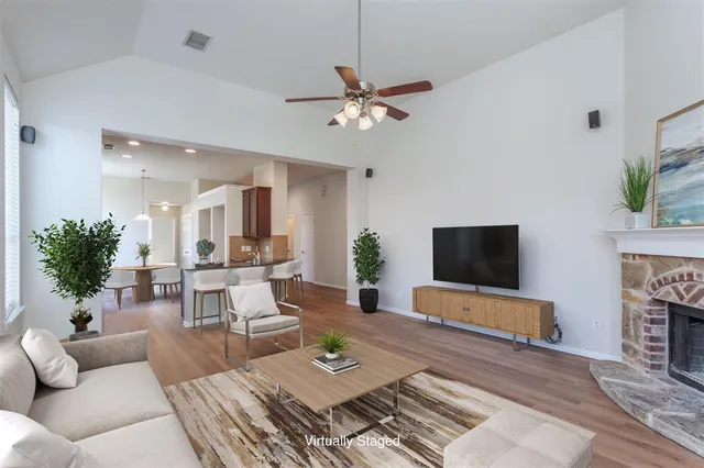 a living room with furniture a fireplace and a flat screen tv
