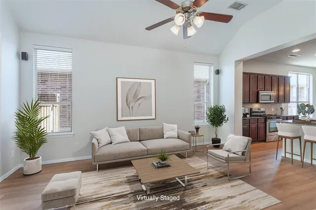 a living room with furniture potted plant and a window
