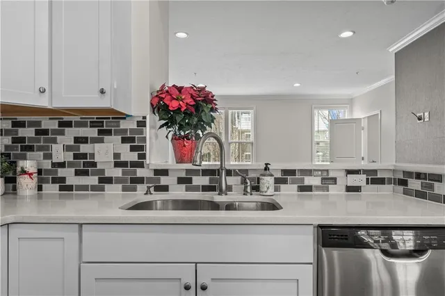 a kitchen with kitchen island granite countertop a sink and cabinets