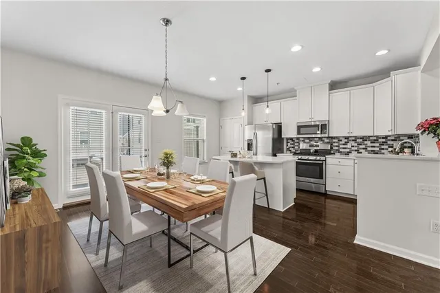 a view of kitchen with cabinets table and chairs