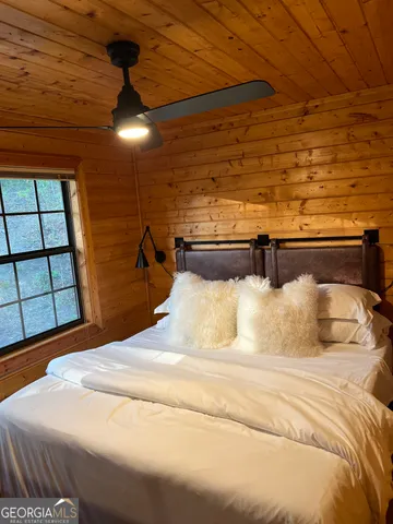 a bedroom with a bed and a large window