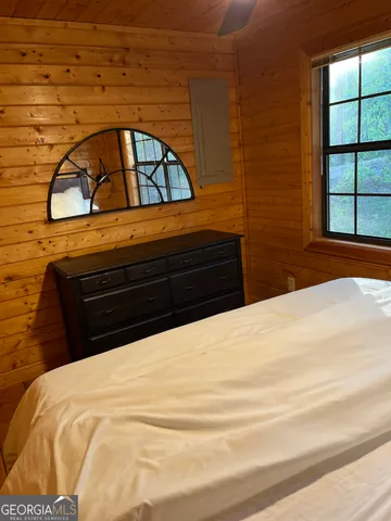 a bedroom with a bed and a large mirror