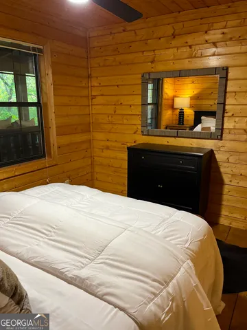 a bed sitting in a bedroom next to a window