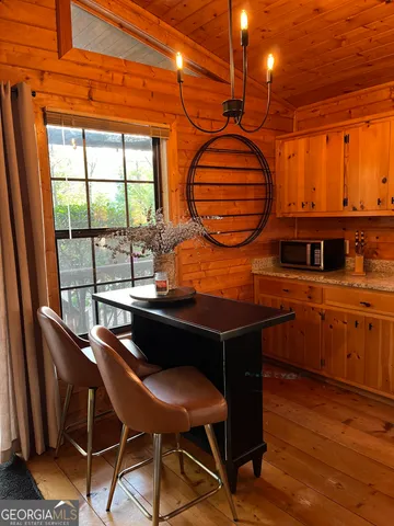 a dining room with furniture and wooden floor