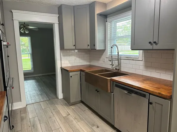 a kitchen with granite countertop a sink and cabinets