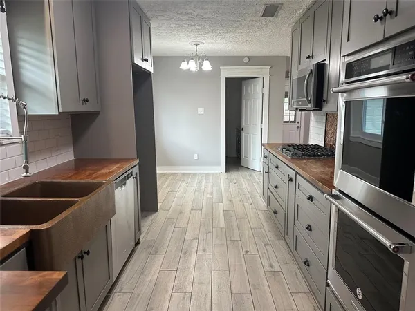 a kitchen with stainless steel appliances granite countertop a stove and a refrigerator