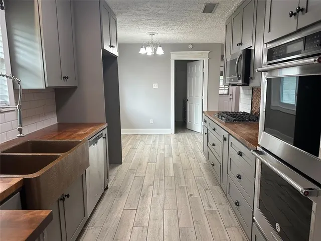 a kitchen with stainless steel appliances granite countertop a stove and a refrigerator