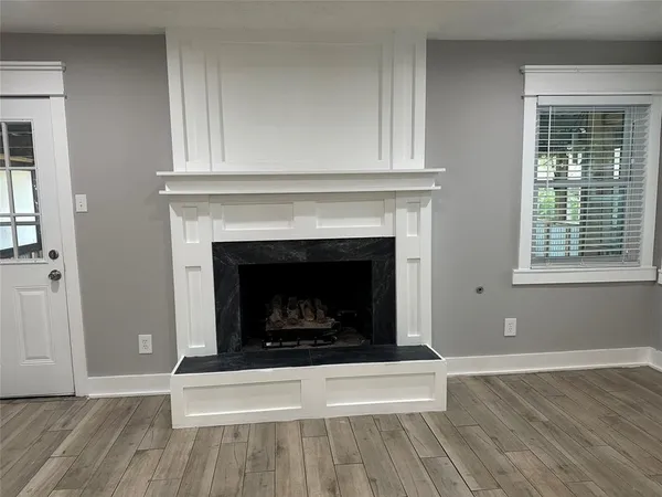a living room with a fireplace and a fireplace