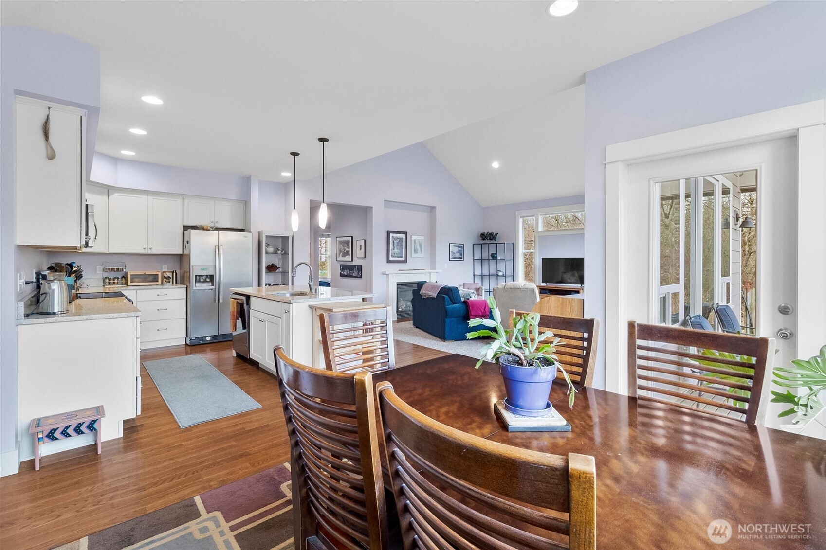 5434 Blue Sky Way Ferndale, WA 98248 - Photo 11 of 39 a kitchen with stainless steel appliances wooden floor dining table and chairs