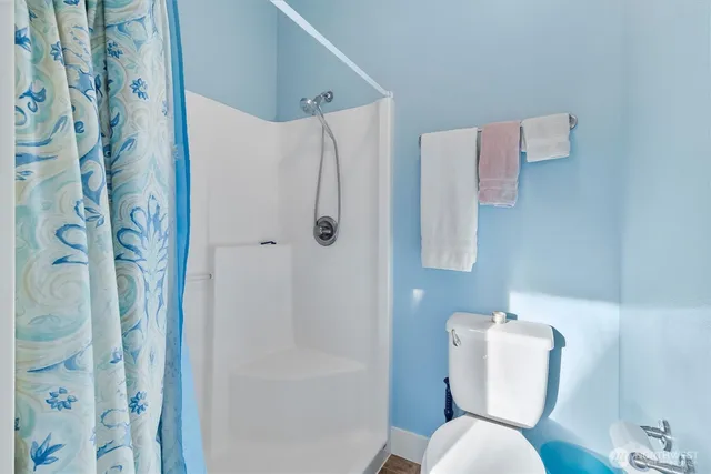 a white toilet sitting next to a bathroom sink