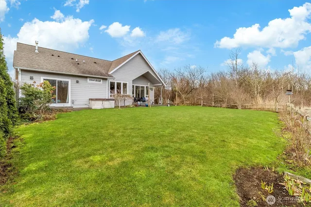 a view of a house next to a big yard with large trees