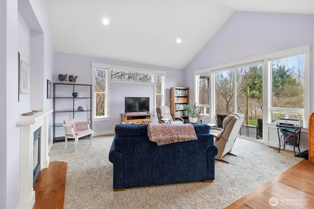a living room with furniture a large window and a flat screen tv