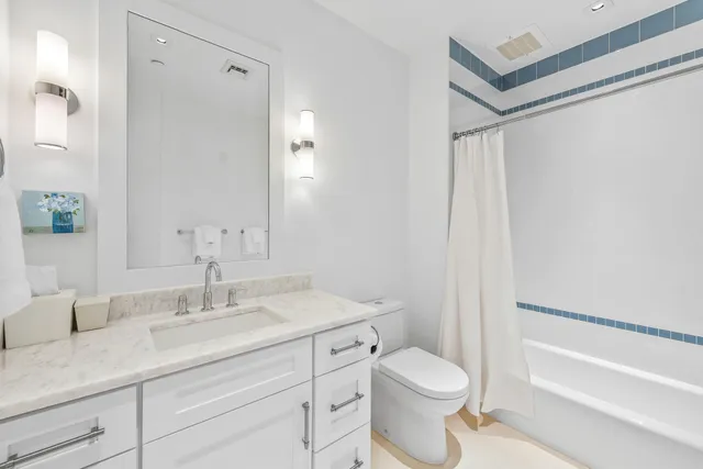 a bathroom with a sink toilet a vanity and shower