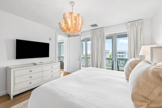 a bedroom with a bed and flat screen tv